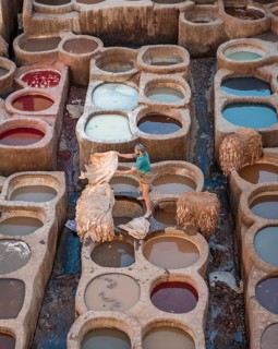 Worker dyeing leather