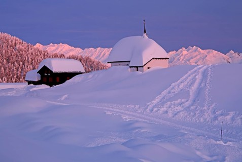 Maria zum Schnee chapel in the snow in the village centre at dusk