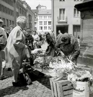 Elderly lady buys a bouquet of flowers