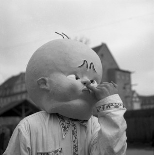 Man with huge baby mask