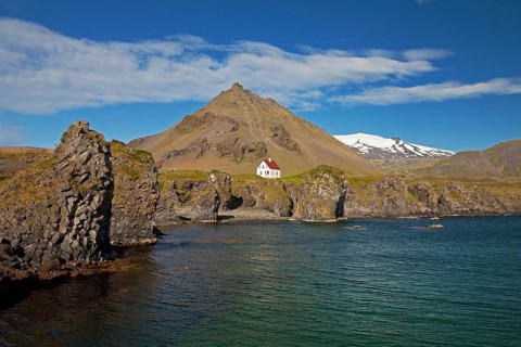 House on the basalt coast off Stapafell mountain and Snaefellsjoekull glacier