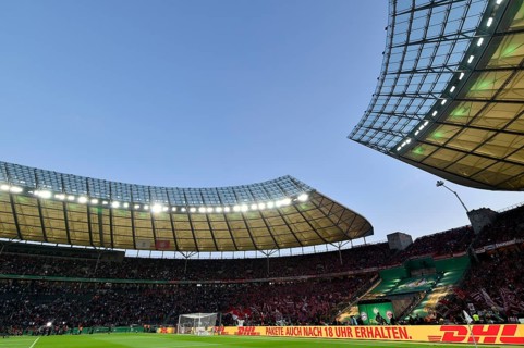 Football stadium illuminated with perimeter advertising