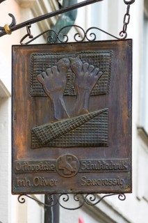 Old hanging shop sign from an orthopedic shoe store