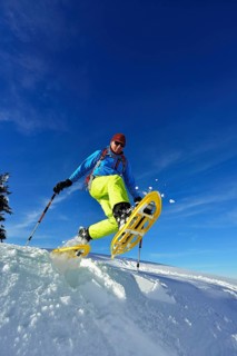 Snowshoe walker with big steps in the snow