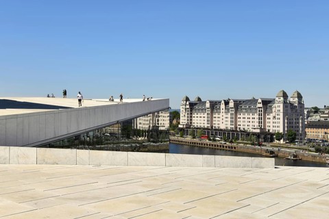 Forecourt and walk-in roof of the new white marble opera house in the back old warehouse district with harbour warehouse
