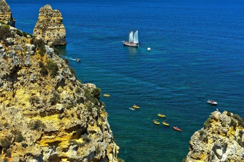 Sailing ship and sea kayaks off Camilo Beach