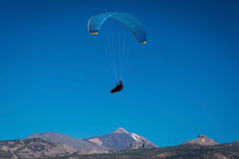 Paraglider over volcanic landscape in front of the Teide