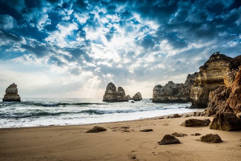 Rocky coast with beach and red rocks
