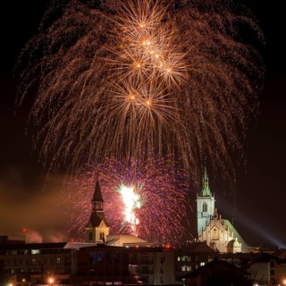 Fireworks over Schwaz on New Year's Eve with Spitalskirche and parish church
