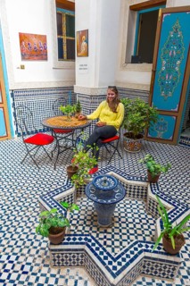 Young woman in a Moroccan courtyard