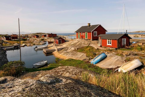 Red wooden houses on the rocky coast