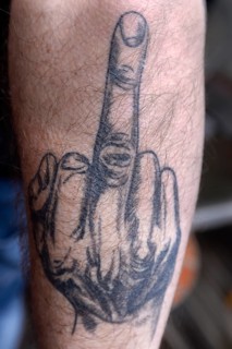 Tattoo with middle finger on arm