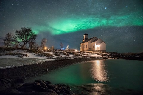 Northern lights over church of Gimsoy