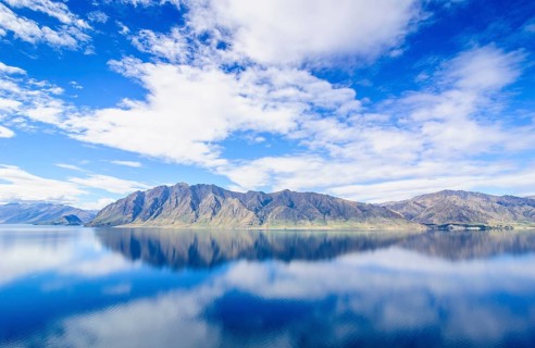 Cloudy sky with water reflections in Lake Hawea
