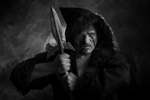 Man with hood and scar in the face