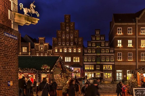 Old gabled houses in Christmas lighting in the evening