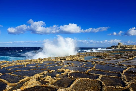 Gozo salt pans by the sea with spray