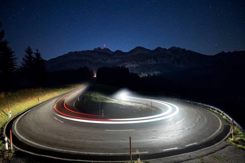 Pass road with cars to Schwagalp with stars and Milky Way