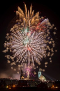 Fireworks over Schwaz on New Year's Eve with hospital church and parish church