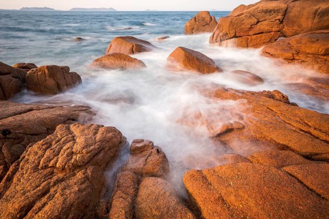 Rocks overflowed by the sea on the pink granite coast