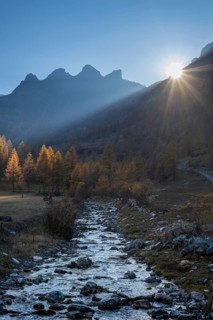 Backlit torrent and mountains