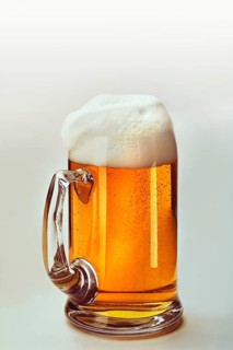 Light beer in a beer mug with a whitecap