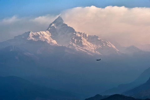 Plane flying to the sacred peak of Machhapuchhare