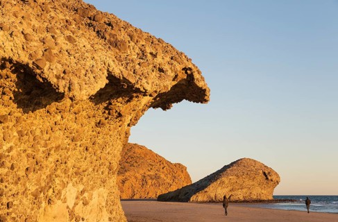 Fossilized lava tongues and walls at the beach Playa del Monsul