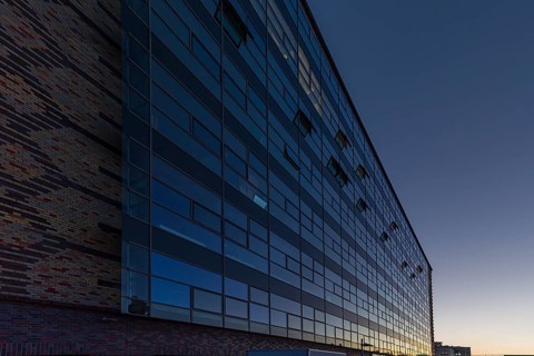 Modernized facade of the former egg cold store at dusk