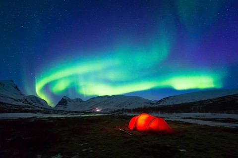 Northern Lights (Aurora borealis) over a tent in winter