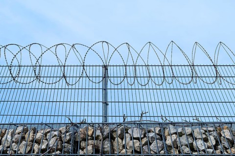 Barbed wire secured stone wall