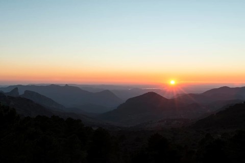 Wooded mountain landscape at sunset