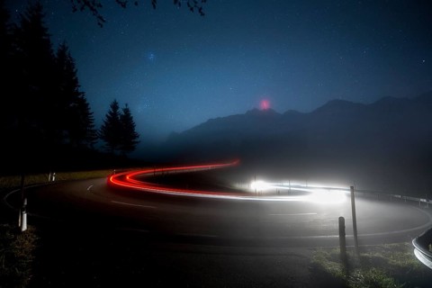 Pass road with cars to Schwagalp with stars and Milky Way