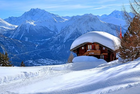 Winter landscape with deep snow-covered chalet in front of Fletschhorn 3985m and Dom 4545m