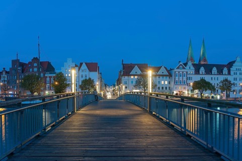 Historical houses with pedestrian bridge over the Trave