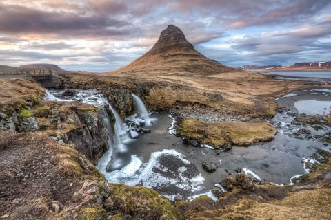 Kirkjufell mountain with Kirkjufellfoss waterfall at sunset