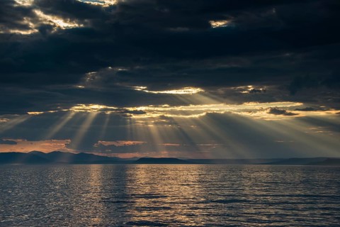 Sun breaking through the clouds above the Amur in Vladivostok