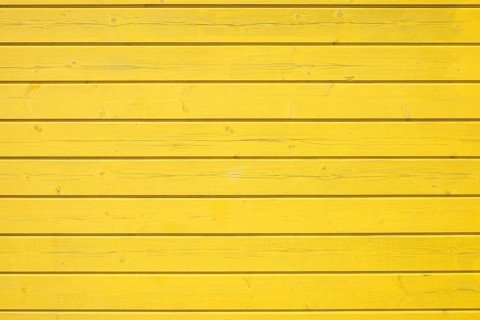 Wooden wall of horizontally arranged yellow painted boards