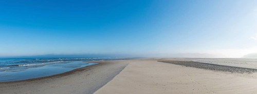 Early mist over the empty beach