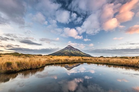 Stratovolcano Mount Taranaki or Mount Egmont reflected in Pouakai Tarn