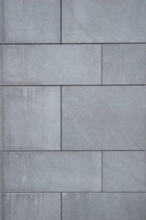 Wallcovering of large dark gray natural stone tiles
