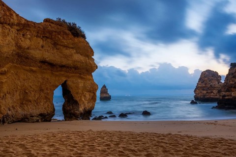 Rocky coast with beach and red rocks