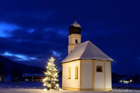St. Leonhard chapel with illuminated Christmas tree during Christmas time