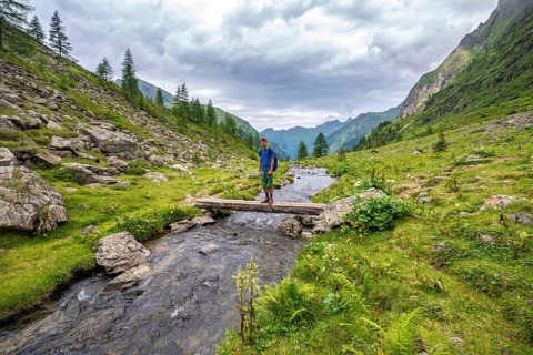 Hiker on a bridge over the Steinriesenbach