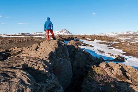 Man stands at Continental Rift between North American and Eurasian Plate