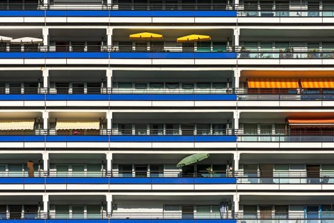Detail of a high-rise facade with balconies on modernized prefabricated buildings