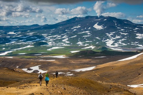 Tourists hiking to the smoking Gorely volcano
