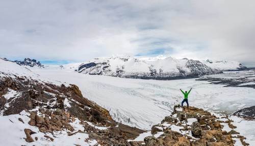 Hiker stretches his arms up