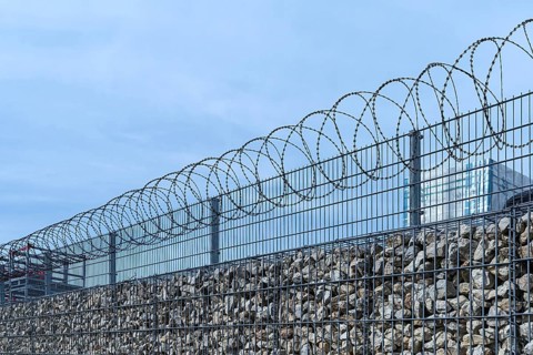 Barbed wire secured stone wall