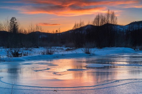 Icy landscape with dramatic sunset